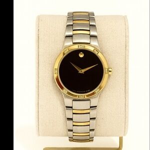 Movado women Elegant Black and Gold Watch with diamonds .